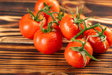 Tomatoes, beautiful bunch of tomatoes in detail on rustic wood, selective focus.