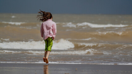 child walking on the beach