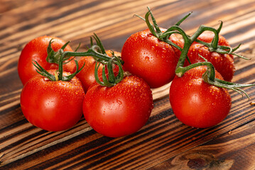 Tomatoes, beautiful bunch of tomatoes in detail on rustic wood, selective focus.