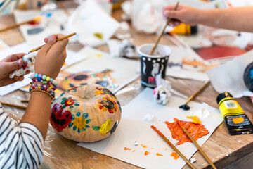 Children's painting class. Painting day with parents in class painting pumpkins.