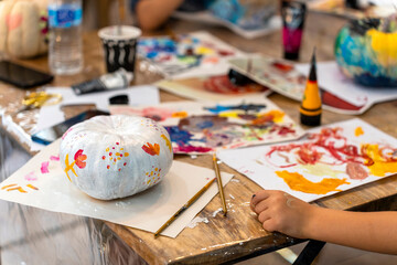 Children's painting class. Painting day with parents in class painting pumpkins.