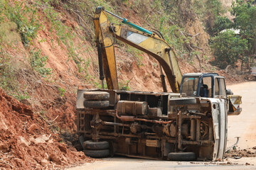 A dump truck that had an accident In the construction area, roads are being pushed with excavators....
