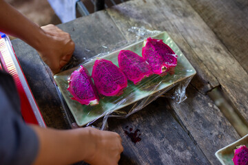 selective focus, specially selected dragon fruit Wrapped with clear plastic. fruit on ceramic...