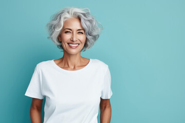portrait of a smiling elderly woman with gray hair against blue background - obrazy, fototapety, plakaty