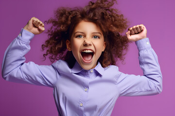 Close up portrait of cheerful positive girl jumping in the air with raised fists looking at camera isolated on pink background.