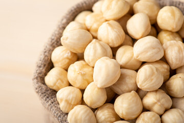 Close up of peeled hazelnuts in linen bag. Fresh tasty hazelnuts in sack
