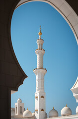 Fototapeta na wymiar Minaret tower in the inner courtyard of Sheikh Zayed Grand Mosque. Abu Dhabi, UAE - 8 February, 2020