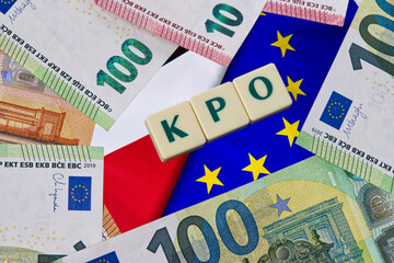 Inscription KPO which is Krajowy Plan Odbudowy next to Euro Money. and EU and Polish Flag Concept showing EU program for Poland.