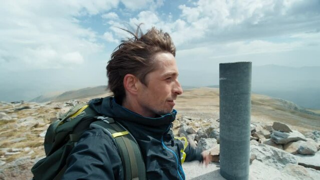 Mountaineer vloger shoot selfie on hiking adventure after reaching the peak