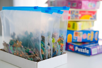 Organization of space and storage of children's board games. Storing puzzles in zip bags.
