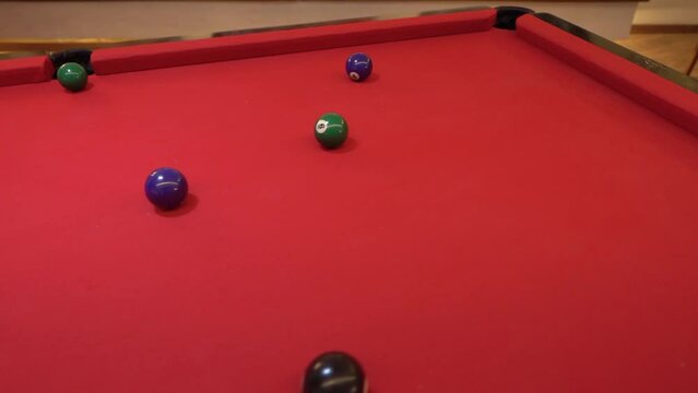 snooker game. close up of hand with cue playing pool on red table