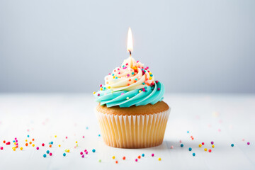 Close up shot of delicious birthday cupcake on light background, celebration muffin with candle ready to be blown, concept of celebration