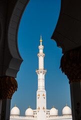 Minaret tower photographed through the arc of Sheikh Zayed Grand Mosque. Abu Dhabi, UAE - 8...