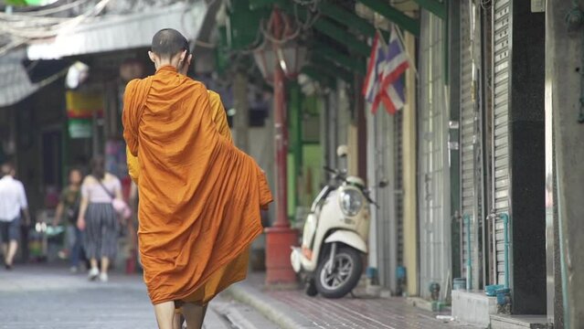 Behind the monks are walking around doing alms as per their morning duties.