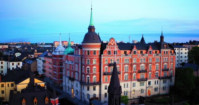 Aerial Panning Shot Of Old Buildings With Spires Amidst Houses In City Against Sky - Stockholm, Sweden