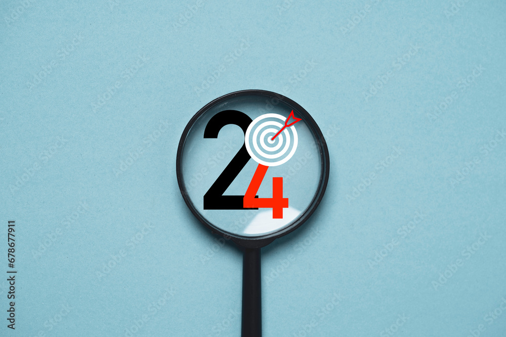 Wall mural 2024 year with dartboard inside of magnifier glass for focusing in objective target include business