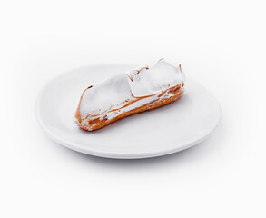 eclair with meringue on white plate