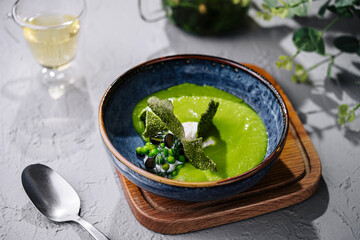 peas, broccoli, spinach cream soup in a bowl