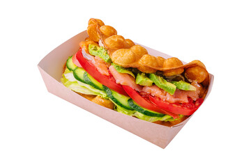 Belgian waffles with salmon, avocado and salad on box