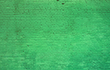The texture of the brick wall of many rows of bricks painted in green color