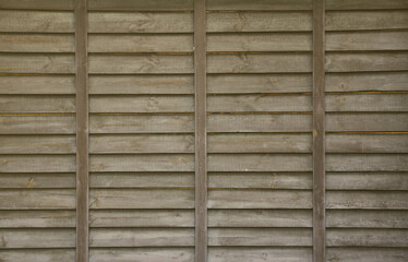 Horizontal texture of a wall from several rows of brown old wooden boards. Painted wooden wall in brown color