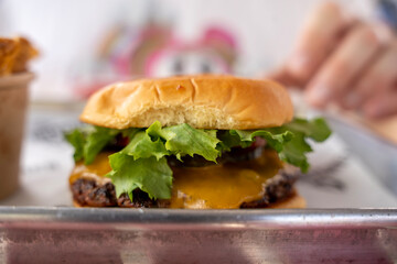 Gourmet Beef Burger with Cheddar on Metal Tray