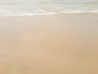 Fototapeta na wymiar wave of sea beach on sandy shore