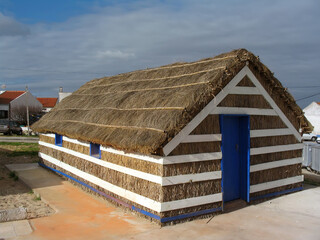 Traditional thatch house of the fishermen and farmers of Carrasqueira, Portugal. Carrasqueira is known for the Stilt Piers or Cais Palafitico on the Sado River. Carrasqueira, Alcacer do Sal, Portugal