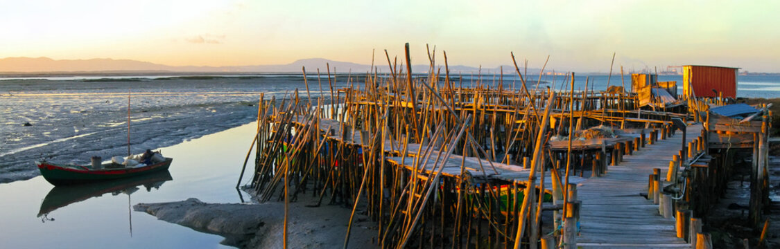 Traditional fishermen wooden jetties. Stilt piers or Cais Palafitico by the Sado River estuary during low tide on Carrasqueira, Alcacer do Sal, Setubal, Portugal