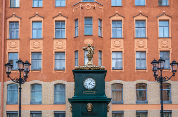 Antique clock on a pedestal in the city square.