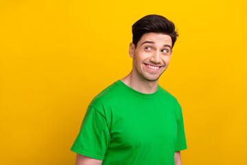 Portrait of young guy in green t shirt smiling cheerful looking empty space for details proposition...