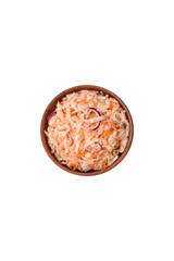 Delicious pickled salted cabbage with carrots, salt and spices