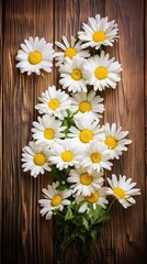 Vibrant daisy blooms arranged on a rustic wooden plank. Minimalist floral card with copy space in vertical orientation. 