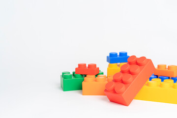 Obraz premium pile plastic toy blocks on white background