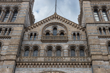 Rounded windows on front of Natural History Museum in central London - 678708540