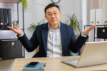 I don't know what to say. Confused business man working on laptop at office workplace. Freelancer...
