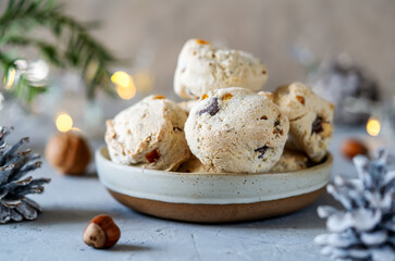 Italian traditional Christmas sweets Cavallucci in ceramic bowl over grey background with xmas decoration