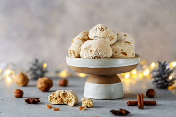 Italian traditional Christmas sweets Cavallucci in ceramic bowl or cake stand over grey background...