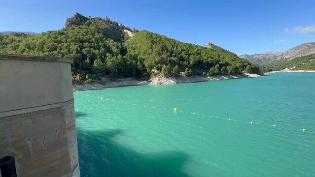 Panoramic view of a dam in a reservoir, in Guadalest village, Spain. The floodgates are open.	