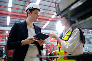 Engineer inspects machinery Maintenance of machinery in the factory.