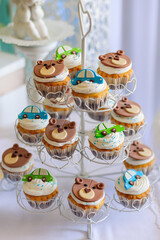 Cupcakes with car and bear on the boy birthday candy bar.