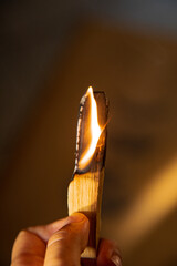 Burning and smoking palo santo on a wooden plate