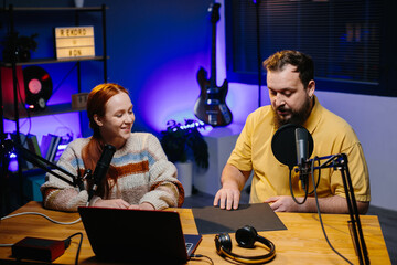 Online bloggers review a new music album on vinyl. A female radio presenter talks to a guest in the...