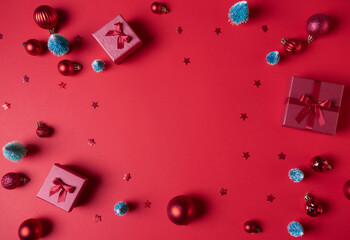 Christmas composition. Christmas red decorations, fir tree branches on red background. Flat lay, top view, copy space, Christmas background.