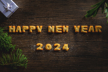 2024,happy new year , the year 2024 written in bread letters on a wood pattern background.