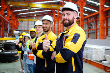 Obraz premium The engineering team and employees are happy to wear safety helmets. Smiling, happy working in the factory.