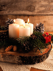 Third Advent candle burning, traditional Christmas decoration