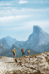 Family hiking expedition in mountains active vacations, parents and child traveling in Norway outdoor adventure tour healthy lifestyle, mother and father mountaineering together with kid in Lofoten - 678733794