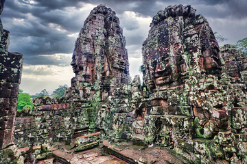 Naklejka premium Bayon Temple - Masterpiece of Khmer Architecture built as a Buddhist temple by Jayavarman VII with over 200 towering smiling and serene looking Buddha faces at Siem Reap, Cambodia, Asia