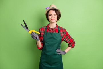Photo of optimistic nice short brown hair lady hold pliers wear cap shirt isolated on pastel green color background